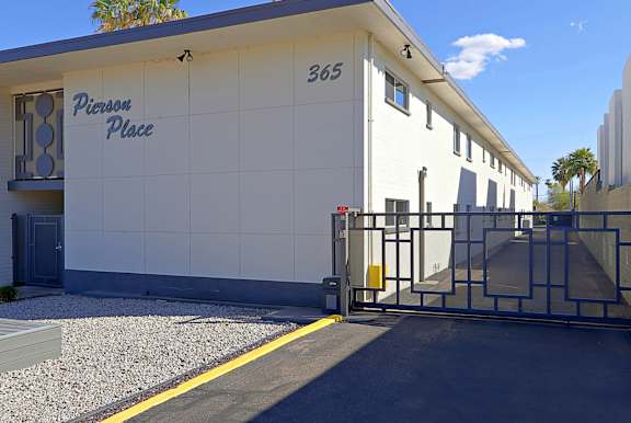 A white building with the number 365 and the name Pierson Place on it.