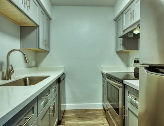 A modern kitchen with stainless steel appliances and wooden accents.