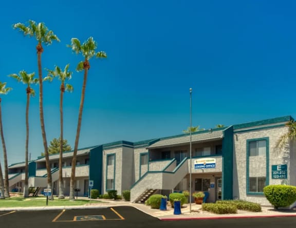 A building with a sign that says "Marine Office" is surrounded by palm trees.