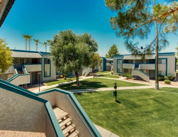 A sunny day at a residential complex with a clear blue sky.