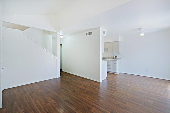 A room with wooden floors and white walls.