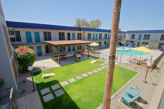 A sunny day at the outdoor pool area of a building.
