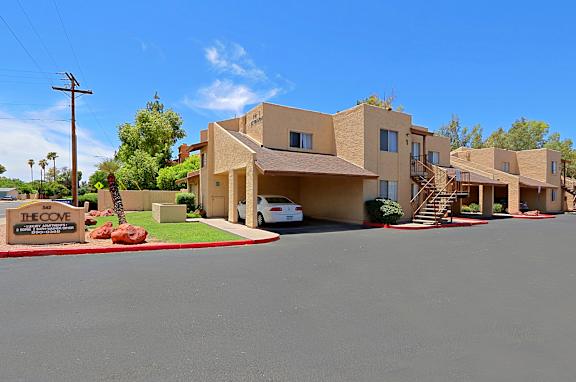 The Cove residential complex with a white car parked in front.