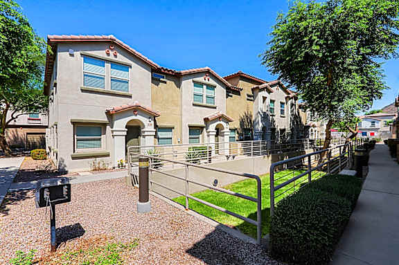 A row of houses with a mailbox in front.