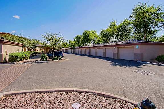 A sunny day in a residential area with a street view.