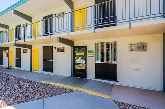 A building with a white facade and yellow doors.