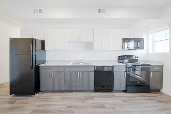 a kitchen with stainless steel appliances and white cabinets a kitchen with stainless steel appliances and white cabinets at 2051 Apartments, Arizona