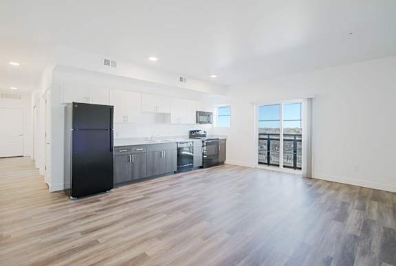 a renovated apartment with a kitchen and a door to a balcony a renovated apartment with a kitchen and a door to a balcony at 2051 Apartments, Prescott, AZ, 86301