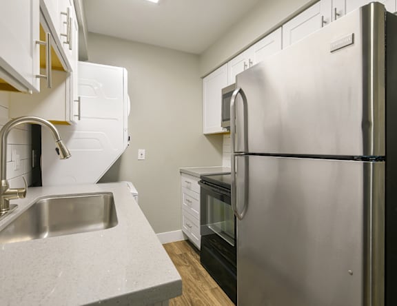 A modern kitchen with a stainless steel refrigerator.