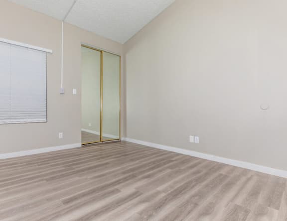 A room with a wooden floor and a glass door.
