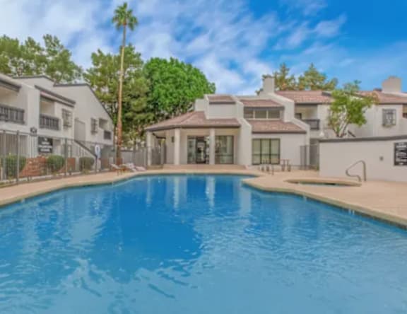 A large swimming pool is the centerpiece of this luxurious home.