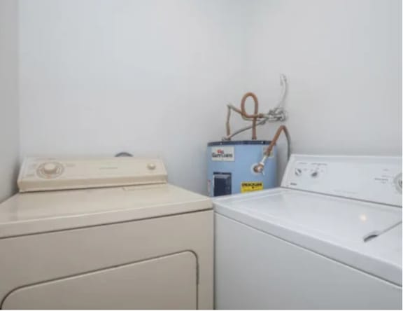 A washing machine and dryer are sitting next to each other.