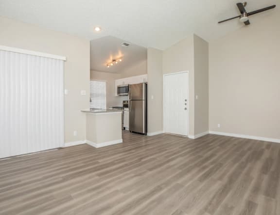 A kitchen area with a refrigerator, microwave, and oven.