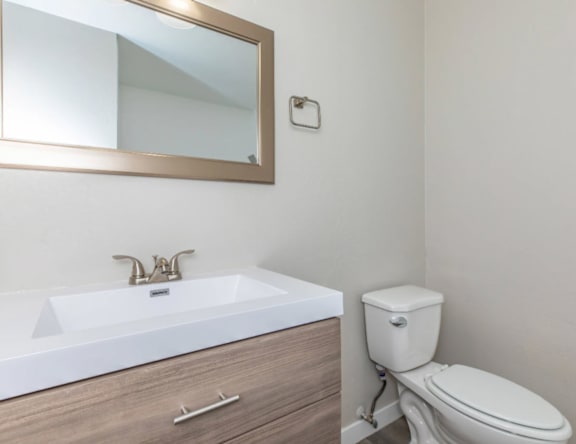 A white toilet sits next to a sink in a bathroom.