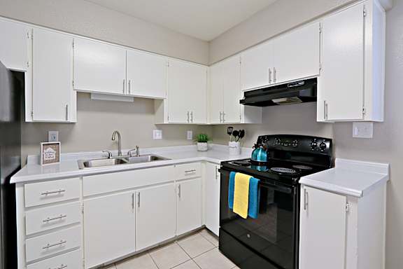 A black stove with a yellow towel on it.