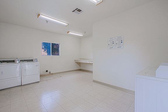 A white room with a washing machine and dryer.