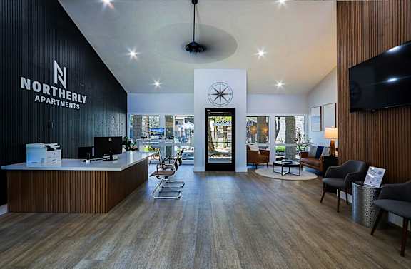 A reception area for Northerly Apartments with a large desk and chairs.