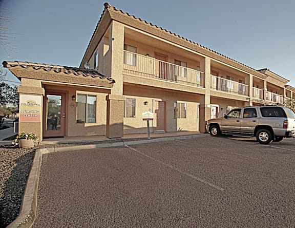 A building with a car parked in front of it.