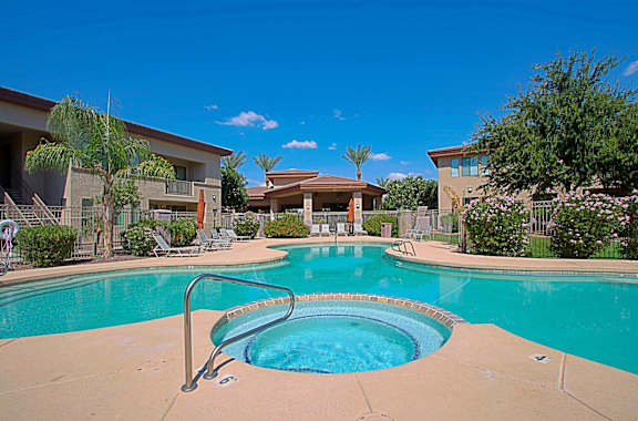 A swimming pool in a residential area with a slide.