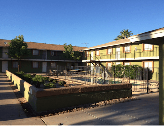 A sunny day at the apartment complex with a clear blue sky.