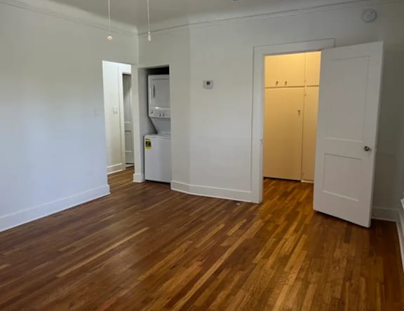 A room with wooden floors and white walls.