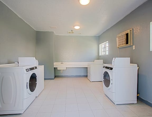 A laundry room with a washer and dryer in it.