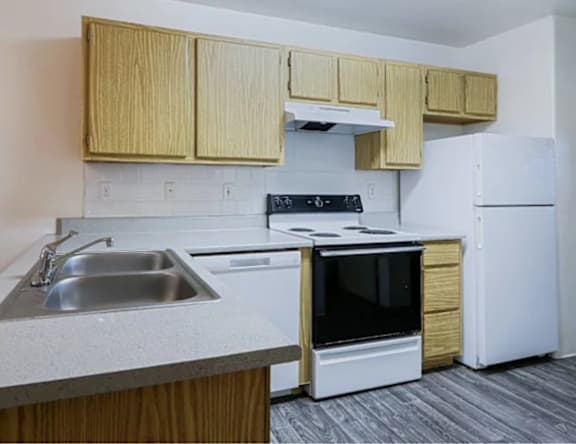 A kitchen with a white oven and white refrigerator.