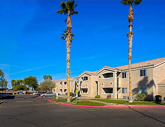 A sunny day at a residential complex with palm trees.