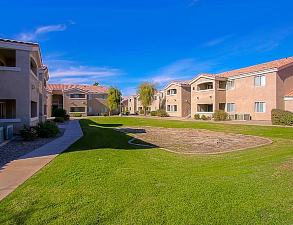 A residential area with houses and a grassy area.