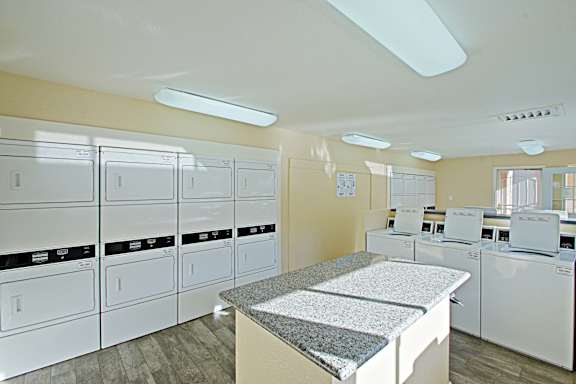 A laundry room with washers and dryers.