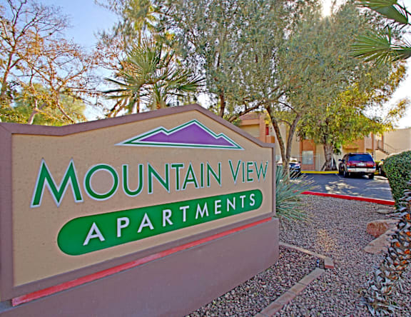 A sign for Mountain View Apartments is shown in front of a building.