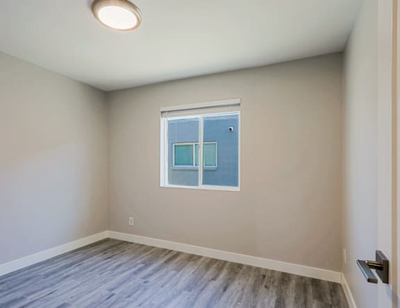 A room with a window and a door.