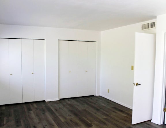 A room with white doors and a white wall.