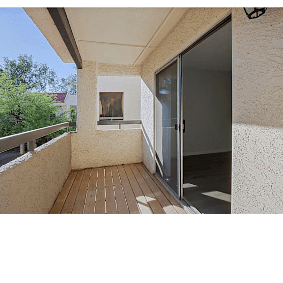 A balcony with a glass door and a window.