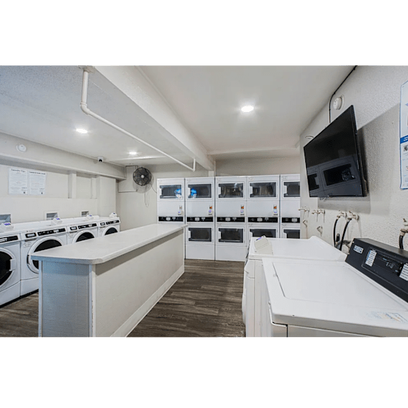A laundry room with washers and dryers.
