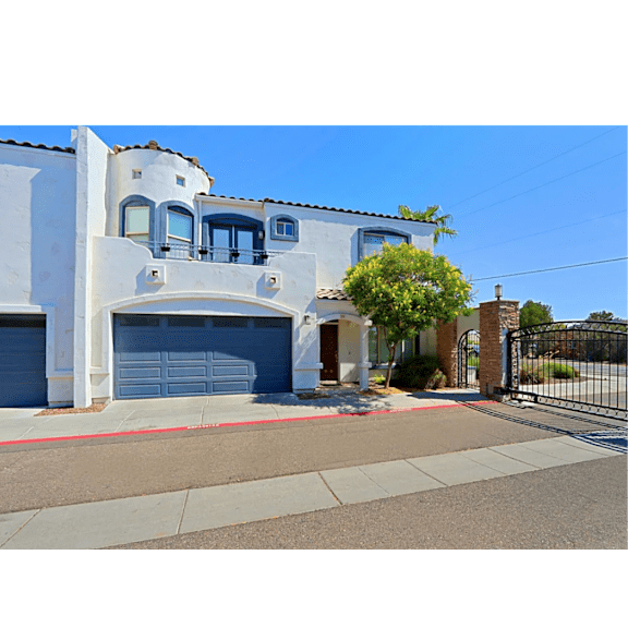 A white house with a blue garage door.