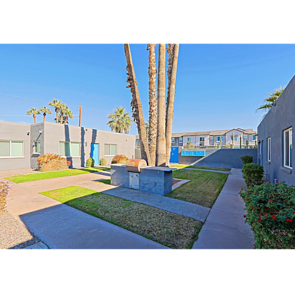 A row of houses with a concrete pathway in the foreground.