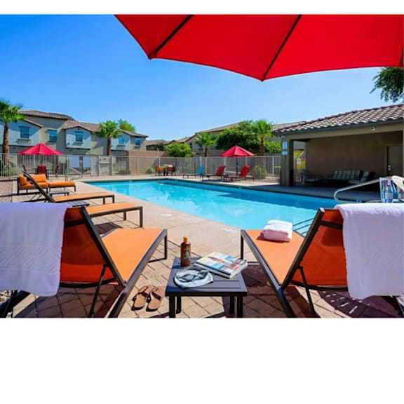 A poolside area with chairs and umbrellas.