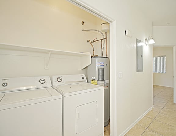 A white washer and dryer in a small room.