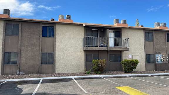 A building with a parking lot in front of it.