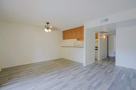 A room with a wooden cabinet and a white wall.