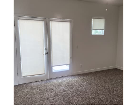 A room with two doors and a window.