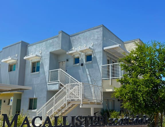 A modern building with the word MACALLISTER in front of it.