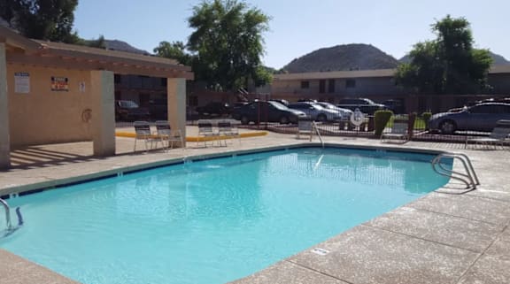 Swimming pool with chairs at Foothills Court Phoenix, Arizona