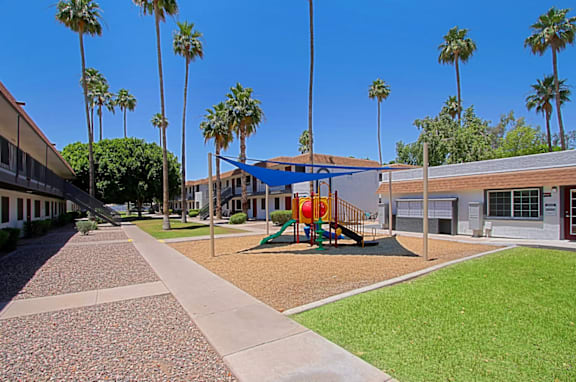 A playground with a slide and a swing set at Aspire Mesa in Mesa, Arizona