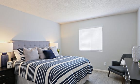 Spacious Bedroom with Plank Flooring and Window with Window Coverings at Summers Point in Arizona, 85301