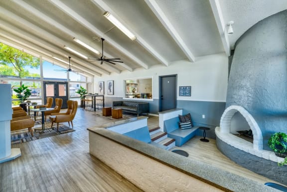 Resident lounge with modern design, an oversized enclosed fireplace with floor to ceiling windows at Connect on Missouri in Phoenix, AZ