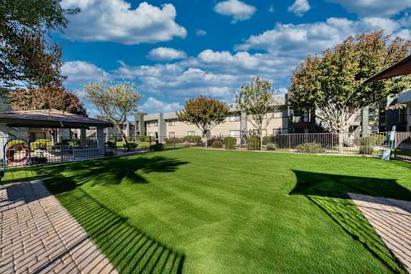 A grassy area with a building in the background.