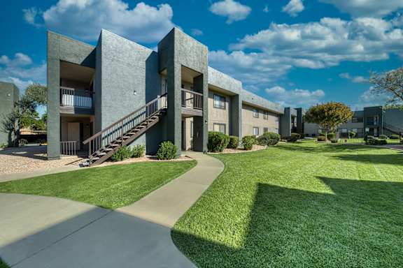 A modern building with a green lawn in front.