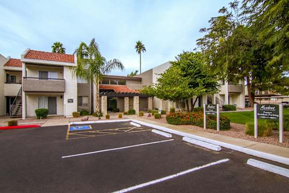 A parking lot in front of a building with a sign that says "Mediterranean.".